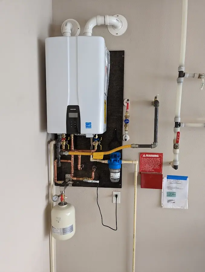 Professional plumber installing copper piping in a Scandia home